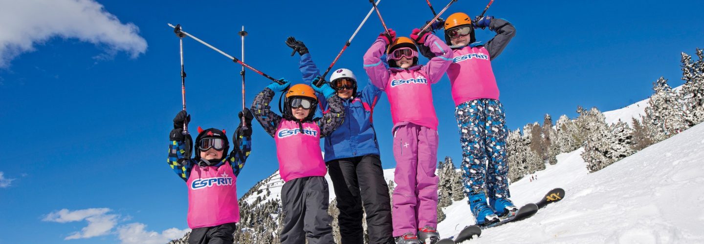 Esprit children on skis with poles in air